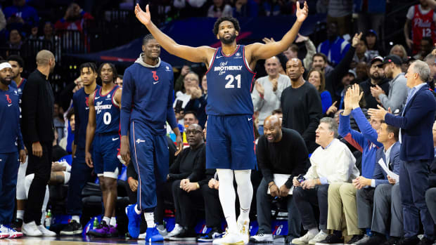 Philadelphia 76ers center Joel Embiid celebrates with fans